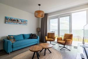 Vakantiewoning aan het strand - tuin en terras met haven- & zeez